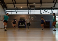 Athletes from the Kaiserslautern Military Community stretch before volleyball tryouts at the Southside Fitness Center on Ramstein Air Base, Germany, Sept. 12, 2017.