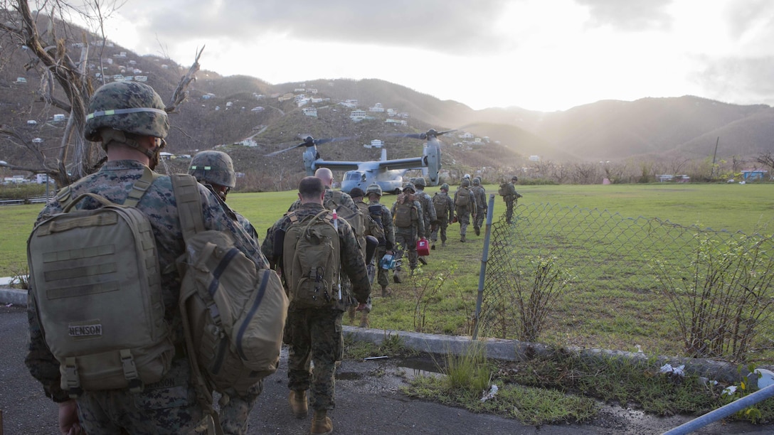 U.S. Marines and Sailors with the 26th Marine Expeditionary Unit (MEU), prepare to board a MV-22B Osprey aircraft after conducting humanitarian aid and relief work in a community affected by Hurricane Irma in St. John, U.S. Virgin Islands, Sept. 17, 2017. The 26th MEU is supporting authorities in the U.S. Virgin Islands with the combined goal of protecting the lives and safety of those in affected areas.