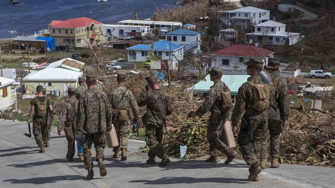U.S. Marines Battalion Landing Team 2nd Battalion, 6th Marine Regiment, 26th Marine Expeditionary Unit (MEU), walk back to a landing zone after clearing roadways in a community affected by Hurricane Irma in St. John, U.S. Virgin Islands, Sept. 17, 2017. The 26th MEU is supporting authorities in the U.S. Virgin Islands with the combined goal of protecting the lives and safety of those in affected areas.