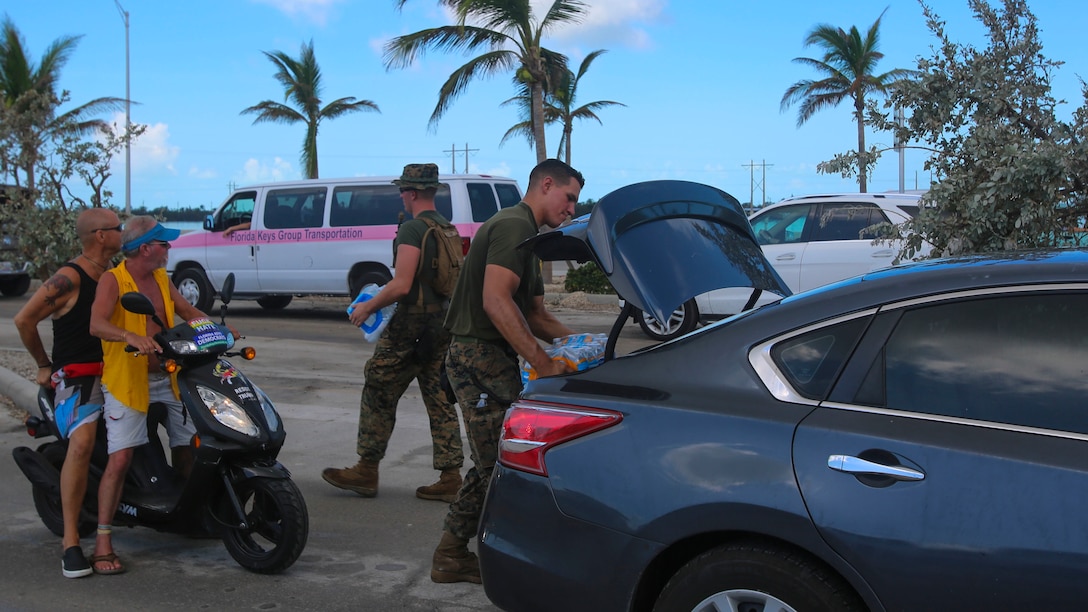 Marines pass out water to citizens at a distribution point in Key West, Fl., Sept. 14, 2017. Marines and Sailors with the 26th Marine Expeditionary Unit helped distribute food, water, and supplies in support of the Federal Emergency Management Agency in the aftermath of Hurricane Irma.