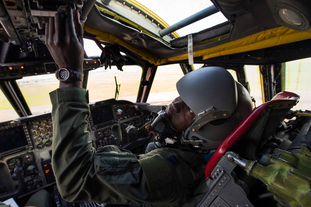 A pilot performs preflight checks on a B-52 Stratofortress.