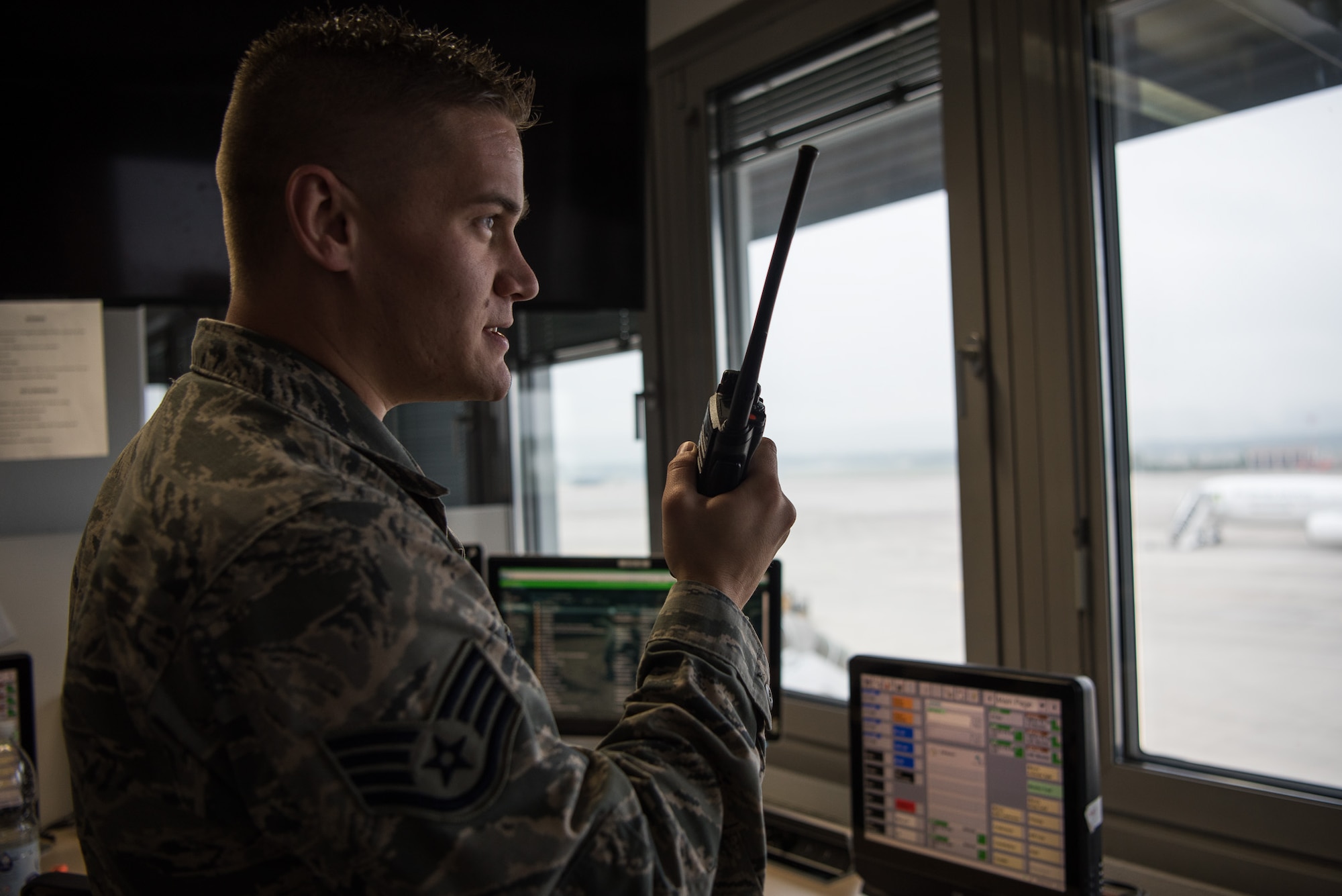 U.S. Air Force Staff Sgt. Ryan Osinski, 721st Aerial Port Squadron Air Terminal Operations Center information controller, speaks to ramp services members to organize the loading of an aircraft on Ramstein Air Base, Germany, Sept. 20, 2017. The 721st APS ATOC flight is responsible for the coordination of all sections to get passengers and cargo loaded onto aircraft. (U.S. Air Force photo by Airman 1st Class Devin M. Rumbaugh)