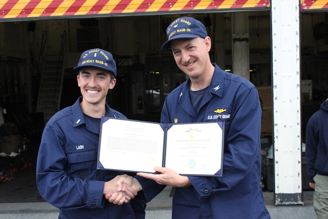 CAPT Tlapa congratulates LTJG Lash upon receiving the Coast Guard Achievement Medal.