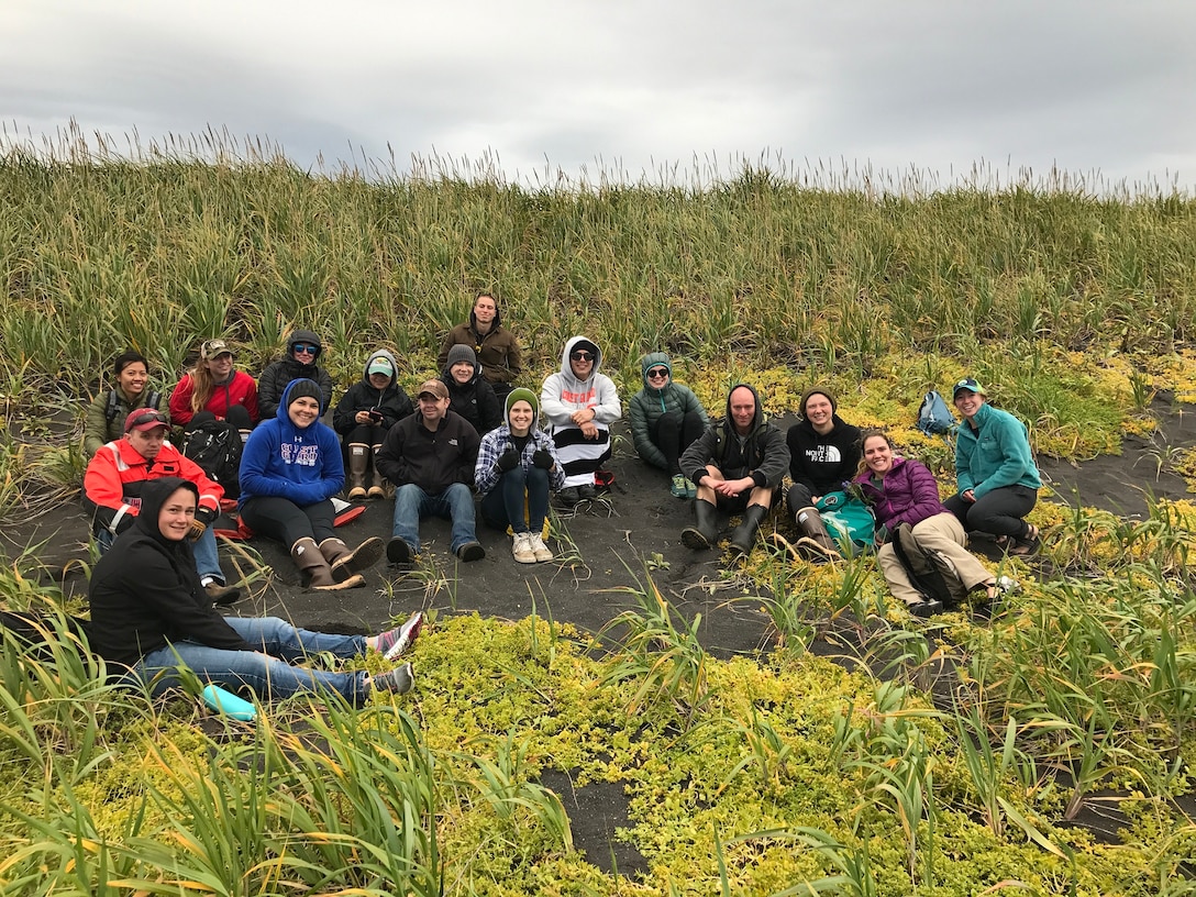 HEALY crewmembers take a break from combing the beach to enjoy the beautiful Alaskan day.