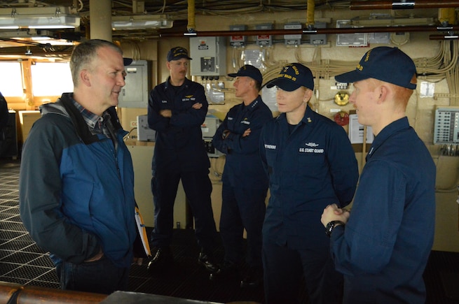 LTJG Brian Hagerty and BMCM Andrea Martynowski show Senator Dan Sullivan the navigation equipment HEALY uses while underway in the Arctic.