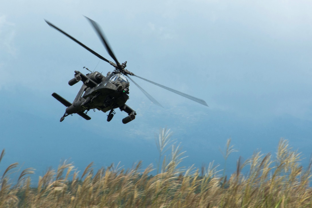 An Army AH-64 Apache helicopter conducts aerial support patrol during a live-fire training.