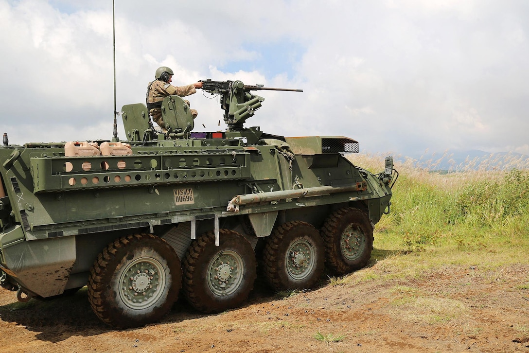 A soldier engages targets with a .50 caliber machine gun from the turret on a tactical vehicle during a live-fire training event.