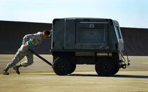 Airman 1st Class Nikolaus Hernandezsire, 92nd Aircraft Maintenance Squadron crew chief, pushes a nitrogen servicing cart during an exercise Sept. 11, 2017, at Fairchild Air Force Base, Washington. The nitrogen servicing cart is used to service certain aircraft, is fully automatic and operates in all types of weather. It is a self-contained, enclosed, skid mount, electric driven designed to produce gaseous Nitrogen to support multiple airframes. (U.S. Air Force photo/Senior Airman Janelle Patiño)