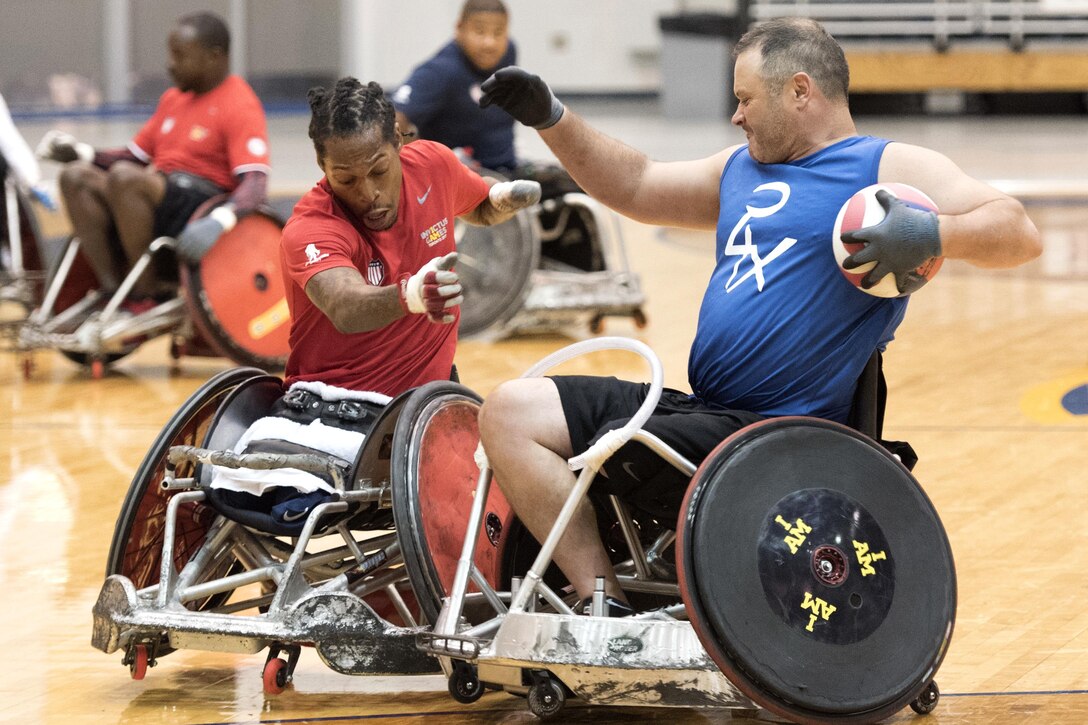 Two players in wheelchairs run into each other.