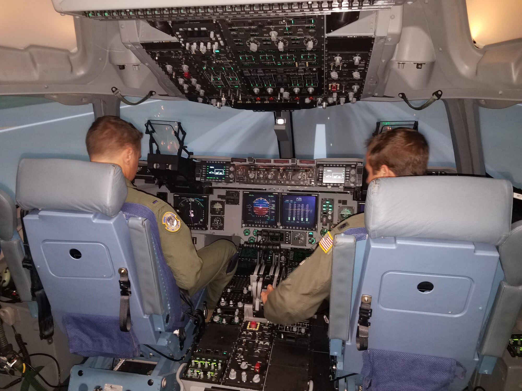 Pilots with the 445th Airlift Wing finish a training session in the cockpit of a C-17 simulator. (U.S. Air Force photo / Brian Brackens)