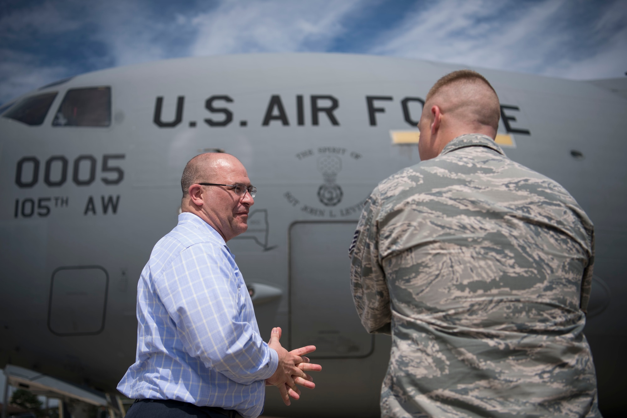 John Levitow Jr., son of Medal of Honor recipient Sgt. John Levitow, speaks to a Levitow Award winner in front of the "Spirit of John Levitow" C-17 Globemaster III on Joint Base McGuire-Dix-Lakehurst, N.J., Aug. 24, 2017. Levitow Jr. visited Joint Base MDL for a base tour and served as the guest speaker for a Kish Airman Leadership School graduation ceremony. (U.S. Air Force photo by Senior Airman Lauren Russell)