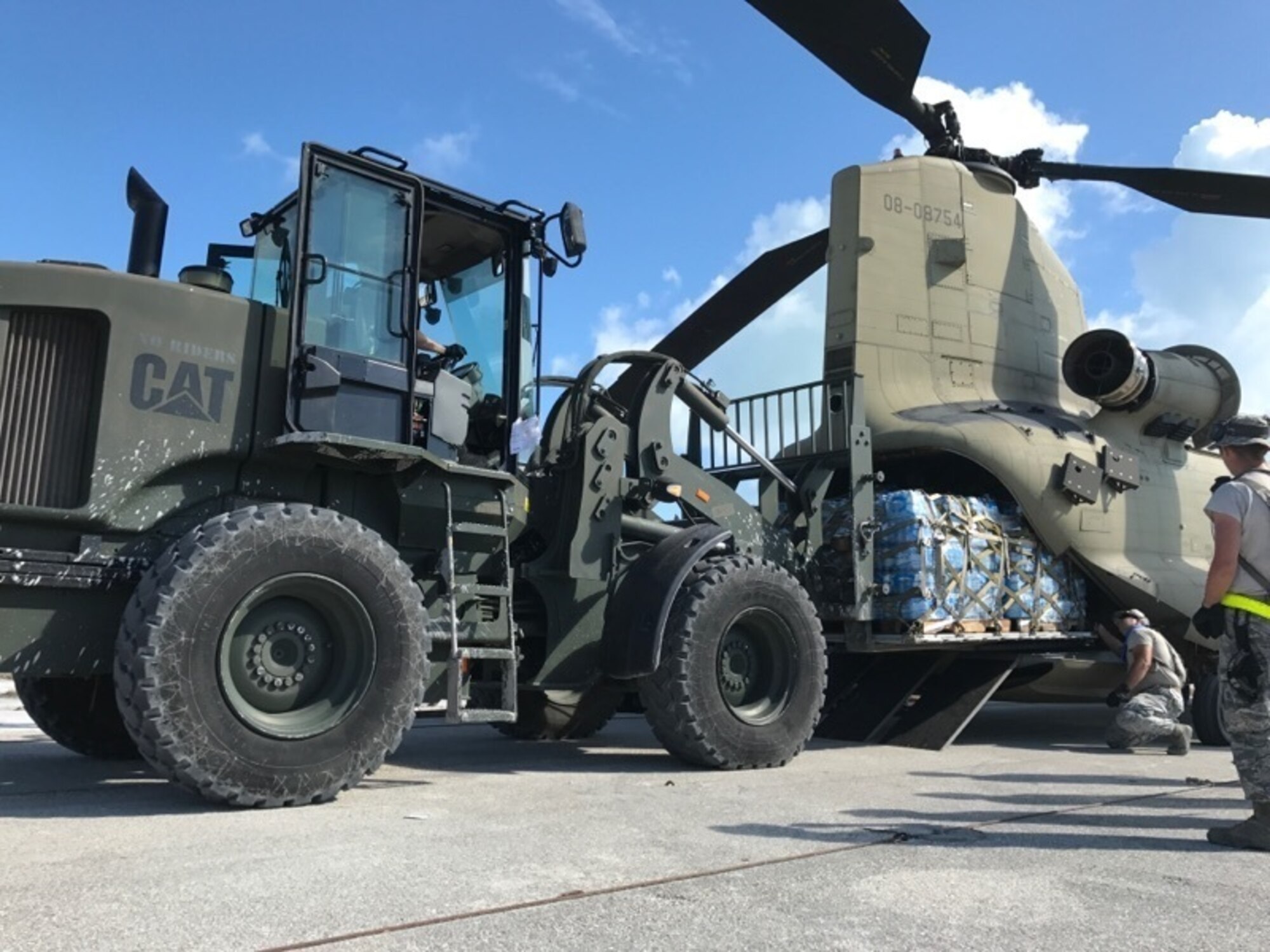 Aerial porters from the 821st Contingency Response Group, load pallets of water onto a CH-47 Chinook helicopter during Hurricane Irma relief efforts, at Marathon, Fla., Sep. 15, 2017. Due to the environment effects following the hurricane, there was a limited supply of potable water, food, and access to power. With support from the local authorities, team members delivered 10,933 cases of Meals Ready to Eat and 16,917 cases of water to the local population. (U.S. Air Force photo by Master Sgt. Jason Masiclat/Released