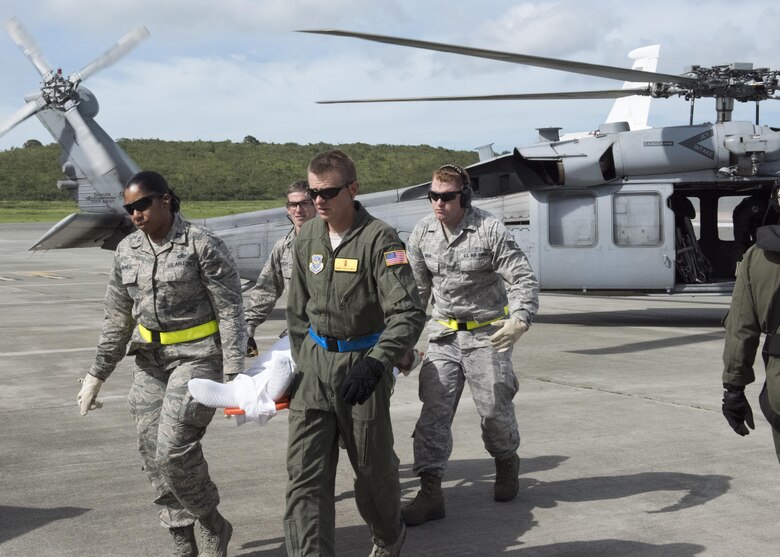 U.S. Air Force personnel deployed from the 60th Medical Group at Travis AFB, California offload a patient from a U.S. Navy MH-60 Helicopter on St. Croix in the U.S. Virgin Islands, Sept. 8, 2017. The Department of Defense in support of the Federal Emergency Management Agency and local officials is assisting in the care and transportation of critical care patients from the islands most impacted by Hurricane Irma earlier this week. (DoD Photo By: USAF Capt Lauren Hill / Released)