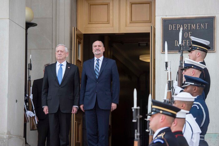 Defense Secretary Jim Mattis stands with the Polish defense minister.
