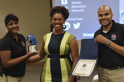 Staff Sgt. Marica Moore, 628th Air Base Wing Equal Opportunity advisor, left, and Toby Housey, 628th ABW EO director, right, present an award to Dr. Melissa Crum, Mosaic Education Network founder and diversity practitioner, for her contribution to the Multicultural Diversity: Real Talk workshop at the Air Base Education Center here Sept. 19, 2017.