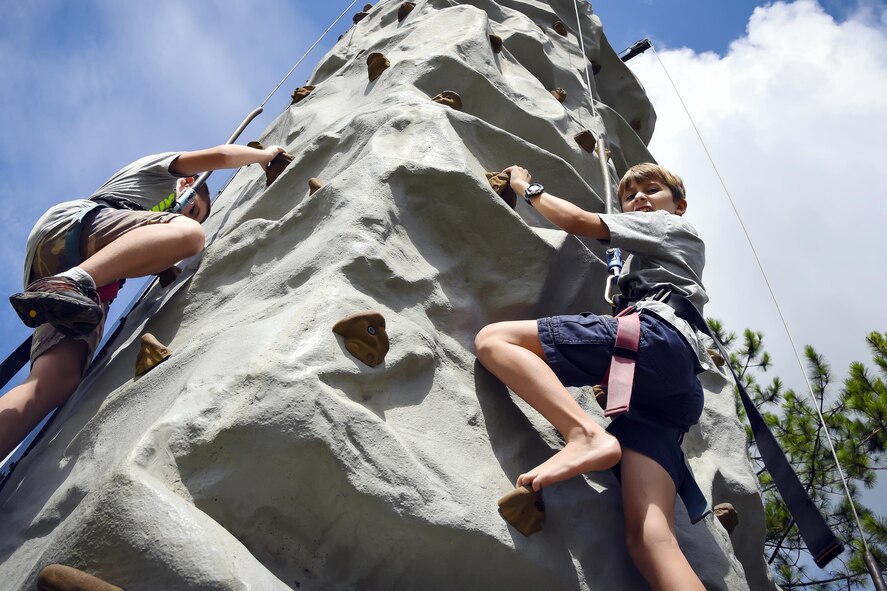 A local child ascends a rock climbing wall during a U.S. Air Force 70th birthday celebration, Sept. 16, 2017, in Valdosta, Ga. The local community and military members joined together to celebrate their 70-year partnership. (U.S. Air Force photo by Airman Eugene Oliver)