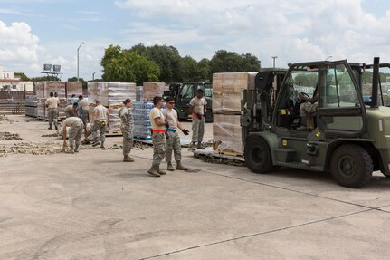 Volunteers from the 502nd Logistics Readiness Squadron, 74th Aerial Port Squadron, 26th APS and 733rd Training Squadron prepare supplies for transport at Joint base San Antonio-Lackland, Texas, for Hurricane Maria relief efforts Sept. 21, 2017.