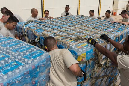 Volunteers from the 502nd Logistics Readiness Squadron, 74th Aerial Port Squadron, 26th APS and 733rd Training Squadron prepare supplies for transport at Joint base San Antonio-Lackland, Texas, for Hurricane Maria relief efforts Sept. 21, 2017.