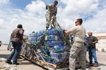 Volunteers from the 502nd Logistics Readiness Squadron, 74th Aerial Port Squadron, 26th APS and 733rd Training Squadron prepare supplies for transport at Joint base San Antonio-Lackland, Texas, for Hurricane Maria relief efforts Sept. 21, 2017.