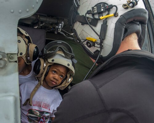 Navy Petty Officer 2nd Class Logan Parkinson prepares a patient's family for evacuation.