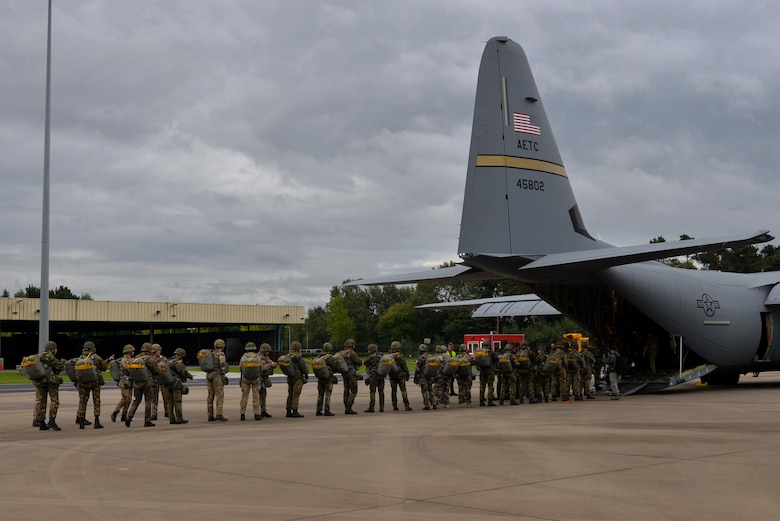 Paratroopers from multiple countries load a C-130J assigned to Little Rock Air Force Base, Ark., Sept. 14, 2017, at Eindhoven Air Base, Netherlands. Aircrew from the 62nd Airlift Squadron conducted a personnel drop over Ginkelse Heide, the drop zone used during Operation Market Garden in 1944. (U.S. Air Force photo by Airman 1st Class Codie Collins)