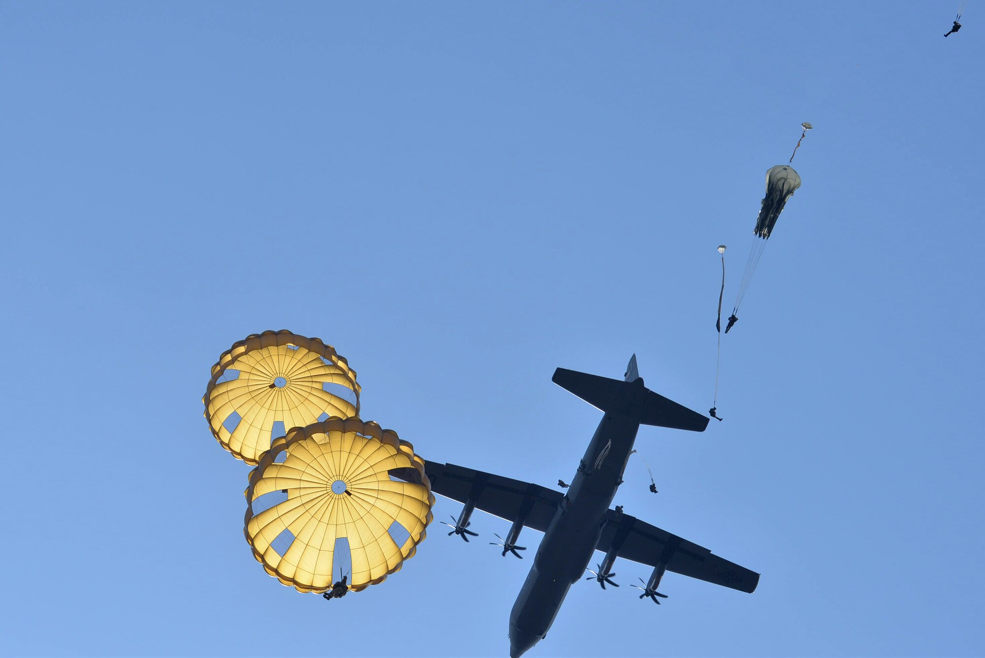 A C-130J from Little Rock Air Force Base, Ark., is flown over the Houtdorperveld Drop Zone as paratroopers conduct a static line jump Sept. 15, 2017, during exercise Falcon Leap. Aircrew members from the 62nd Airlift Squadron worked alongside eight different nations to honor and remember the sacrifices made in 1944 during Operation Market Garden. (U.S. Air Force photo by Airman 1st Class Codie Collins)