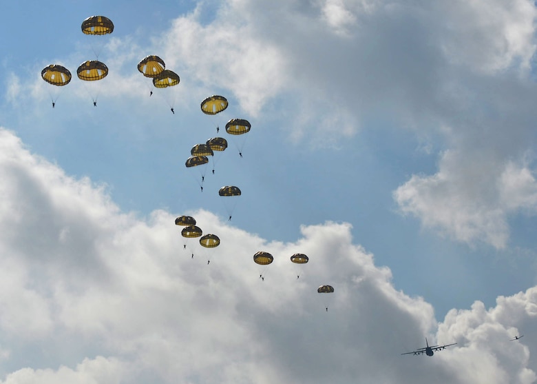 Paratroopers from multiple countries jump from a C-130J assigned to Little Rock Air Force Base, Ark., Sept. 14, 2017, at Eindhoven Air Base, Netherlands. Aircrew from the 62nd Airlift Squadron conducted a personnel drop over Ginkelse Heide, the drop zone used during Operation Market Garden in 1944. (U.S. Air Force photo by Airman 1st Class Codie Collins)
