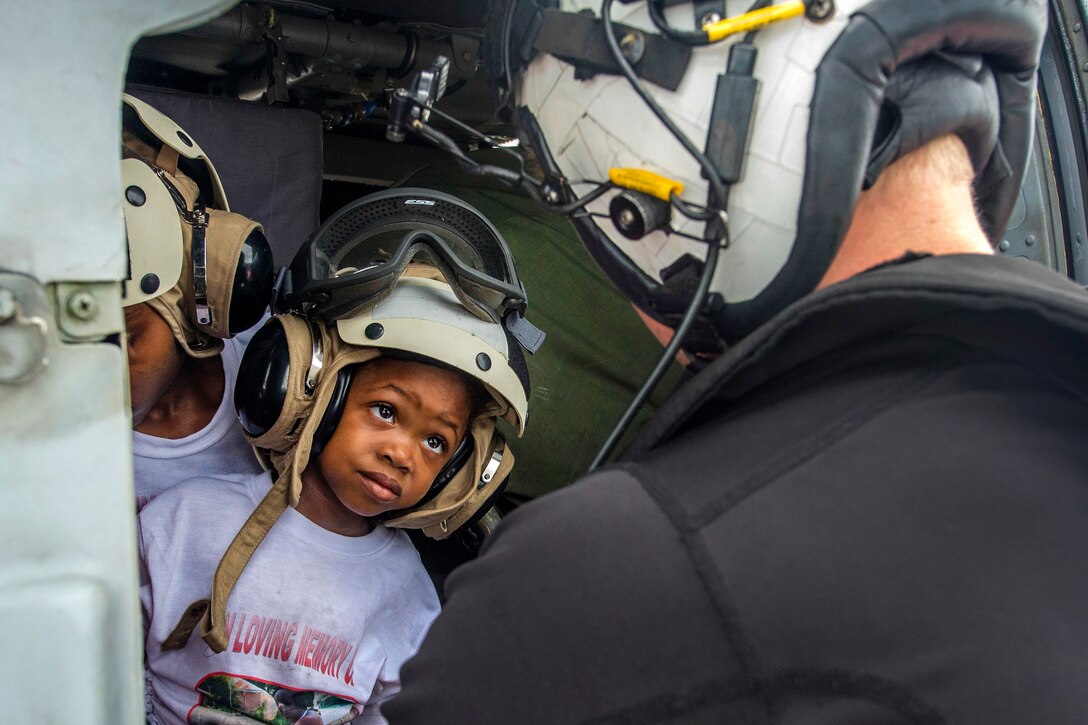 A young boy gets ready to be evacuated in a helicopter.