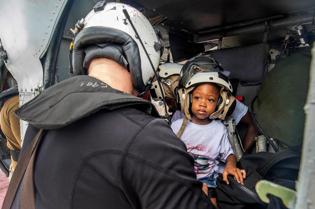 A sailor prepares a patient's family for evacuation.