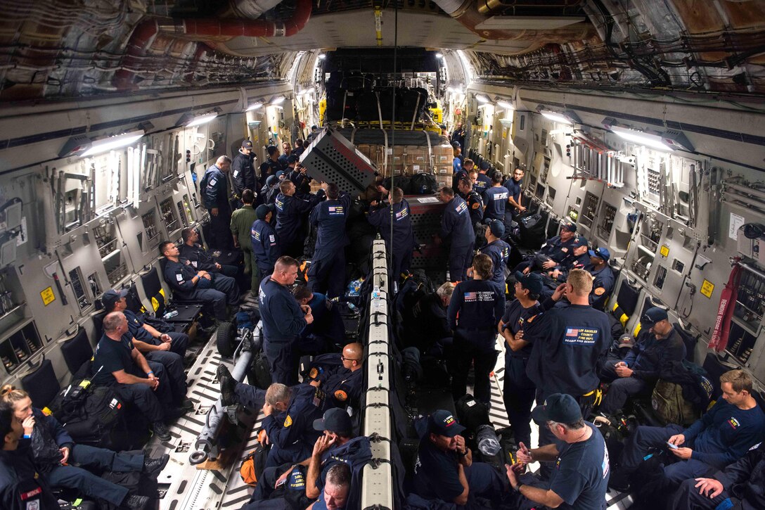 Team members prepare to fly on a C-17 Globemaster III.