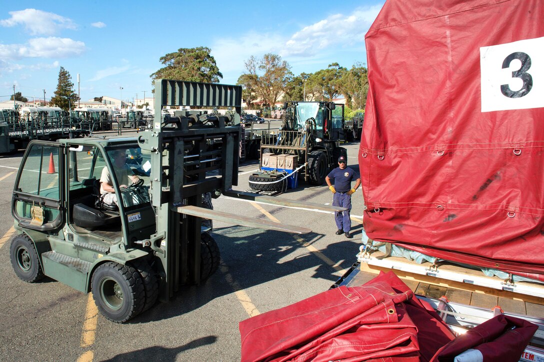 An airman operates a forklift.