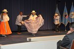 Latin dance group, facing viewer on stage