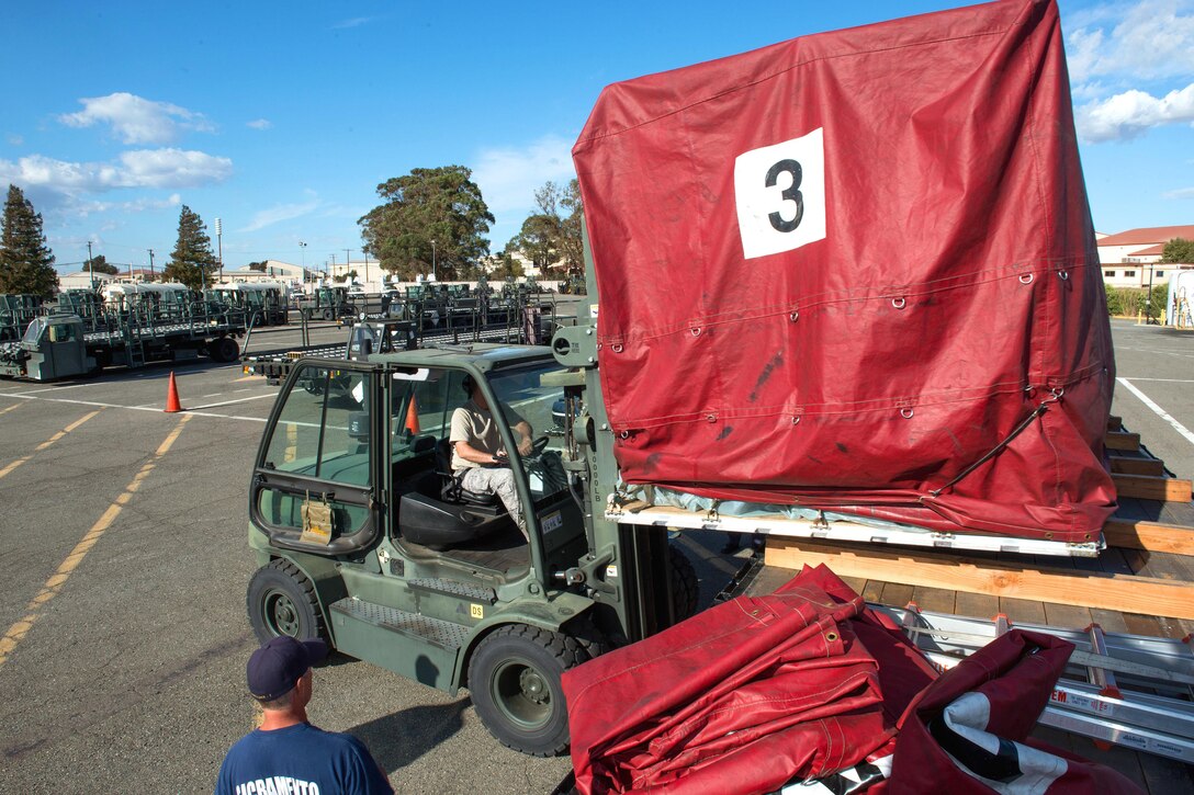 An airman operates a forklift.