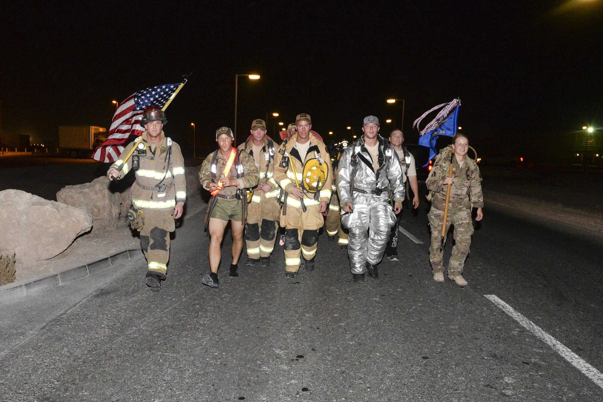 U.S. Air Force fire department and security forces members participate in an evening 9/11 memorial walk at Al Udeid Air Base, Qatar, Sept. 11, 2017.
