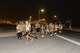 U.S. Air Force fire department and security forces members participate in an evening memorial walk at Al Udeid Air Base, Qatar, Sept. 11, 2017.