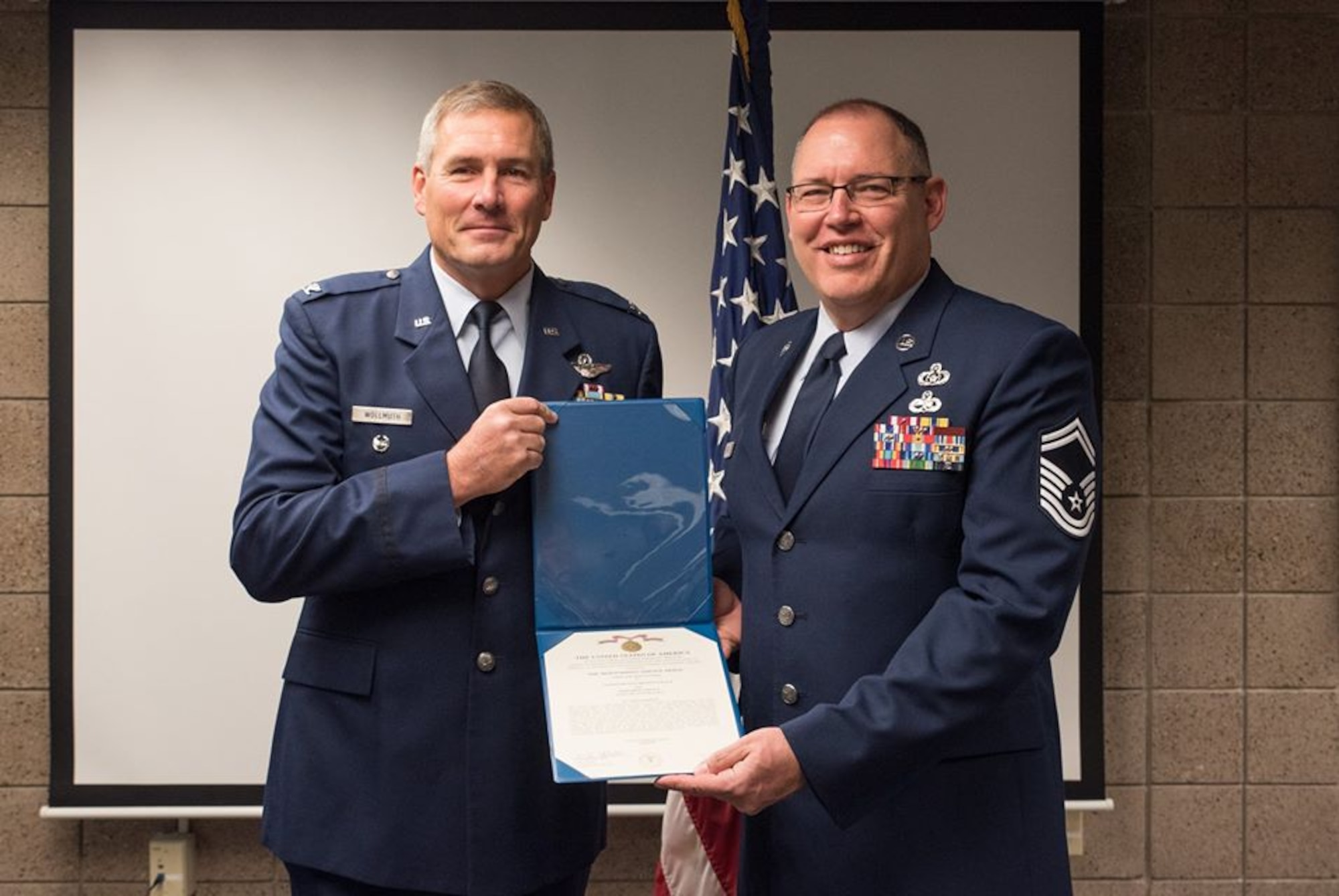 Col. Tim Wollmuth, 934th Airlift Wing vice commander, presents the Air Force Meritorious Service Medal to Senior Master Sgt. Brent Black Sept. 9. (Air Force Photo/Master Sgt. Eric Amidon)