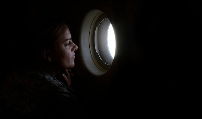 Maj. Beth Janssen, Air Force A3, looks out a window of a C-17 Globemaster III during Operation Uggianaqtuq, while flying over the Bering Strait on course for Point Barrow, Alaska, Sept. 9, 2017. Janssen was part of the Air Force Arctic Security Expedition designed to inform senior Air Force leaders about emerging challenges in the Arctic. The operation took them to Alaska, Greenland and as far north as Alert, Canada. (U.S. Air Force photo by Tech. Sgt. Dan DeCook)