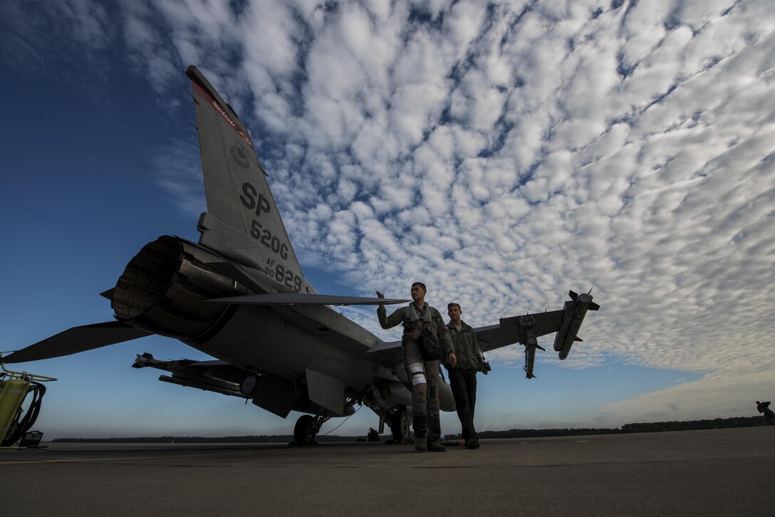 Senior Airman Joseph Clark, 52nd Aircraft Maintenance Squadron crew chief, and a pilot from the 480th Fighter Squadron, conduct a pre-flight inspection at Krzesiny Air Base, Poland, Sept. 11, 2017, in support of Aviation Rotation 17-4. The exercise focused on maintaining joint readiness while building interoperability capabilities and helps strengthen relationships and engagements with allies. (U.S. Air Force photo by Staff Sgt. Jonathan Snyder)