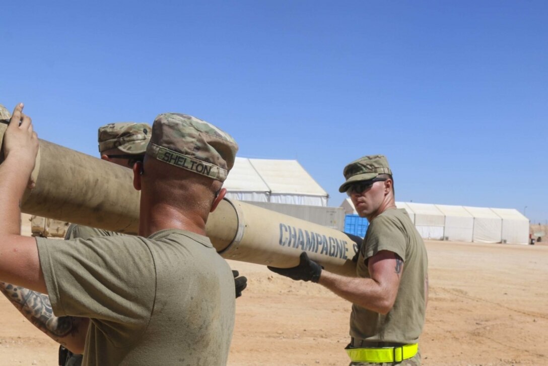 Army Spc. Matthew Shelton, a gunner, and Army Spc. Philip Roberts, a driver, both assigned to Charlie Company, 2nd Battalion, 7th Cavalry Regiment, 3rd Armored Brigade Combat Team, 1st Cavalry Division, install the gun tube after tightening the bore evacuator on an M1A2 Abrams Main Battle Tank while conducting maintenance during Exercise Bright Star 2017 at Mohamed Naguib Military Base, Egypt, Sept. 10, 2017. The exercise provides an opportunity to build partnership and mutual cooperation in the fight against terrorism in the region. Army photo by Staff Sgt. Leah R. Kilpatrick