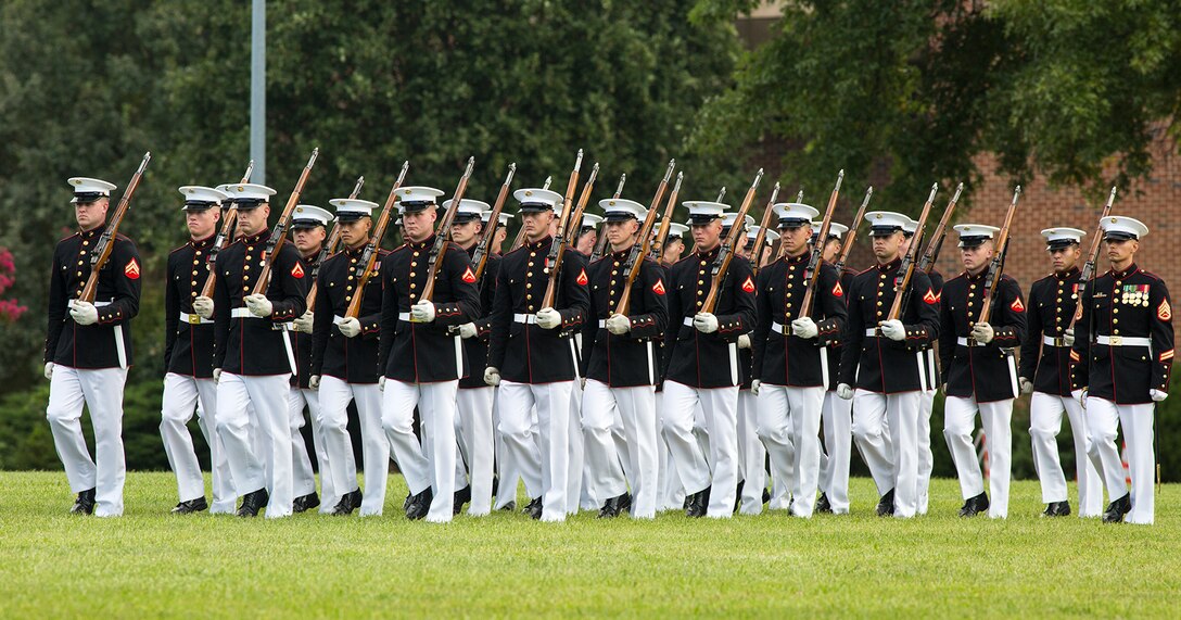 Marines of the U.S. Marine Corps Silent Drill Platoon march onto the parade deck during the Enlisted Awards Parade at the Modern Day Marine Military Exposition (MDMME) at Lejeune Field, Marine Corps Base Quantico, Quantico, Va., Sept. 20, 2017. The MDMME is an annual exposition open to the public to display the progression of equipment and technology that is currently employed and may be utilized with future Marine Corps operating forces. (Official U.S. Marine Corps photo by Cpl. Robert Knapp/Released)
