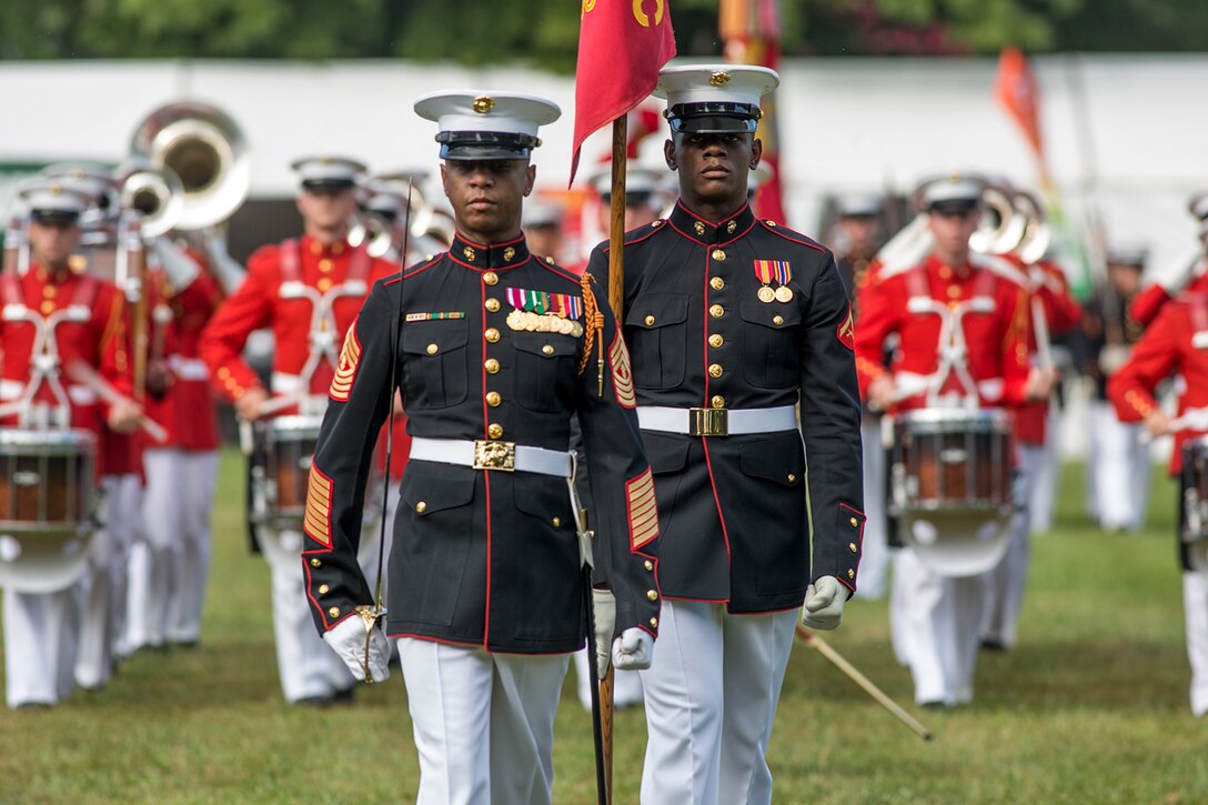 Master Gunnery Sgt. Kevin Buckles, drum major, “The Commandant’s Own” U.S. Marine Drum & Bugle Corps, and Lance Cpl. Joshua Lawson, Bravo Company guidon bearer, Marine Barracks Washington D.C., march across the parade deck during the Enlisted Awards Parade at the Modern Day Marine Military Exposition (MDMME) at Lejeune Field, Marine Corps Base Quantico, Quantico, Va., Sept. 20, 2017. The MDMME is an annual exposition open to the public to display the progression of equipment and technology that is currently employed and may be utilized with future Marine Corps operating forces. (Official U.S. Marine Corps photo by Cpl. Robert Knapp/Released)