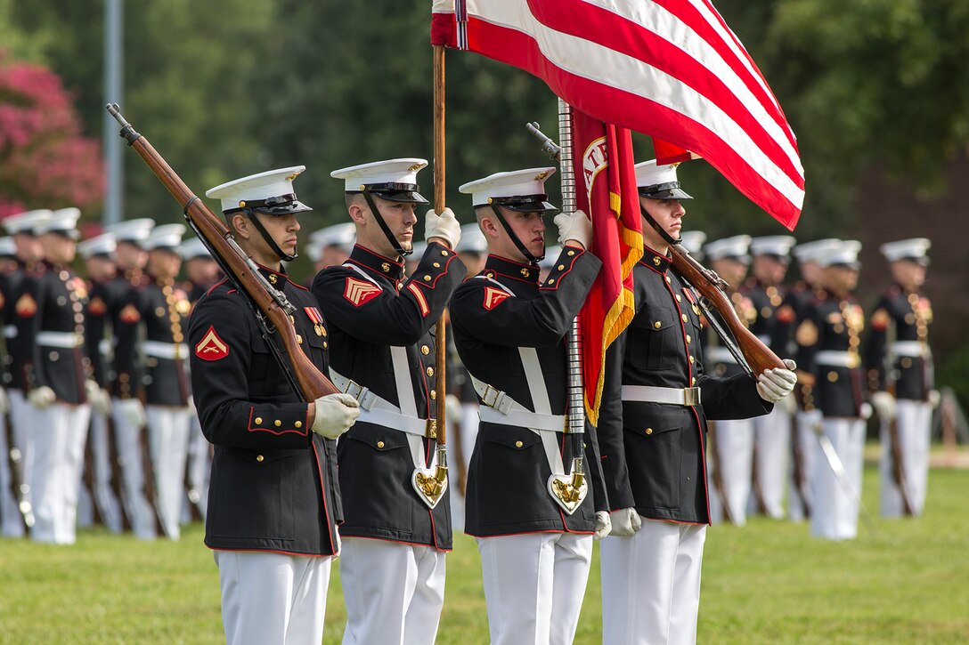 Marines of the U.S. Marine Corps Color Guard stand at attention during the Enlisted Awards Parade at the Modern Day Marine Military Exposition (MDMME) at Lejeune Field, Marine Corps Base Quantico, Quantico, Va., Sept. 20, 2017. The MDMME is an annual exposition open to the public to display the progression of equipment and technology that is currently employed and may be utilized with future Marine Corps operating forces. (Official U.S. Marine Corps photo by Cpl. Robert Knapp/Released)