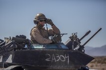 A Marine awaits instructions on the radio for the next phase of a battalion attack during Large Scale Exercise-17 at Twentynine Palms, Calif., Aug. 15-18, 2017. LSE-17 is a multinational exercise, led by 2nd Marine Division, with elements from the United Kingdom, France, Canada and II Marine Expeditionary Force, focused on integrating all capabilities of the Marine Air-Ground Task Force and coalition forces.  (U.S. Marine Corps photo by Lance Cpl. Taylor Cooper)