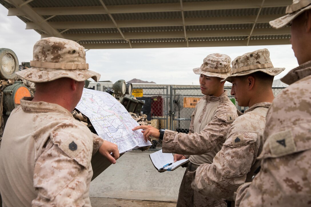 U.S. Marines with Apache Company, 3rd Light Armored Reconnaissance Battalion, Marine Air-Ground Task Force-8 (MAGTF), review the scheme of maneuver prior to departure in support of the final exercise during Integrated Training Exercise 5-17 (ITX), on Marine Corps Air Ground Combat Center Twentynine Palms, Calif., Aug. 3, 2017. The purpose of ITX is to create a challenging, realistic training environment that produces combat-ready forces capable of operating as an integrated MAGTF. (U.S. Marine Corps photo by Cpl. Christopher A. Mendoza)
