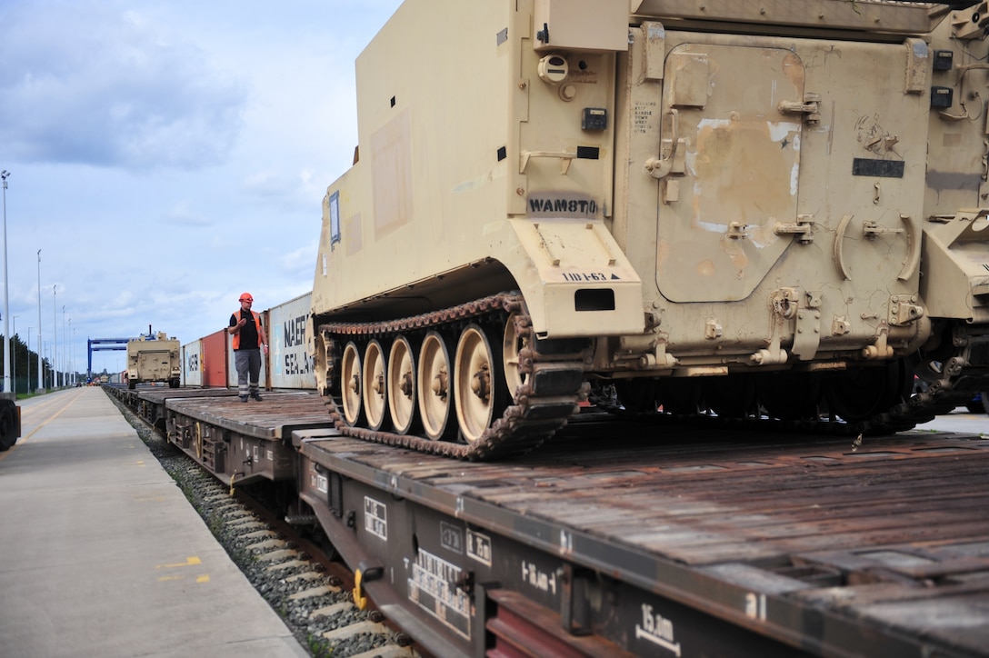 M577 Armored Command Vehicles are driven on to train cars at the port of Gdansk, Poland.