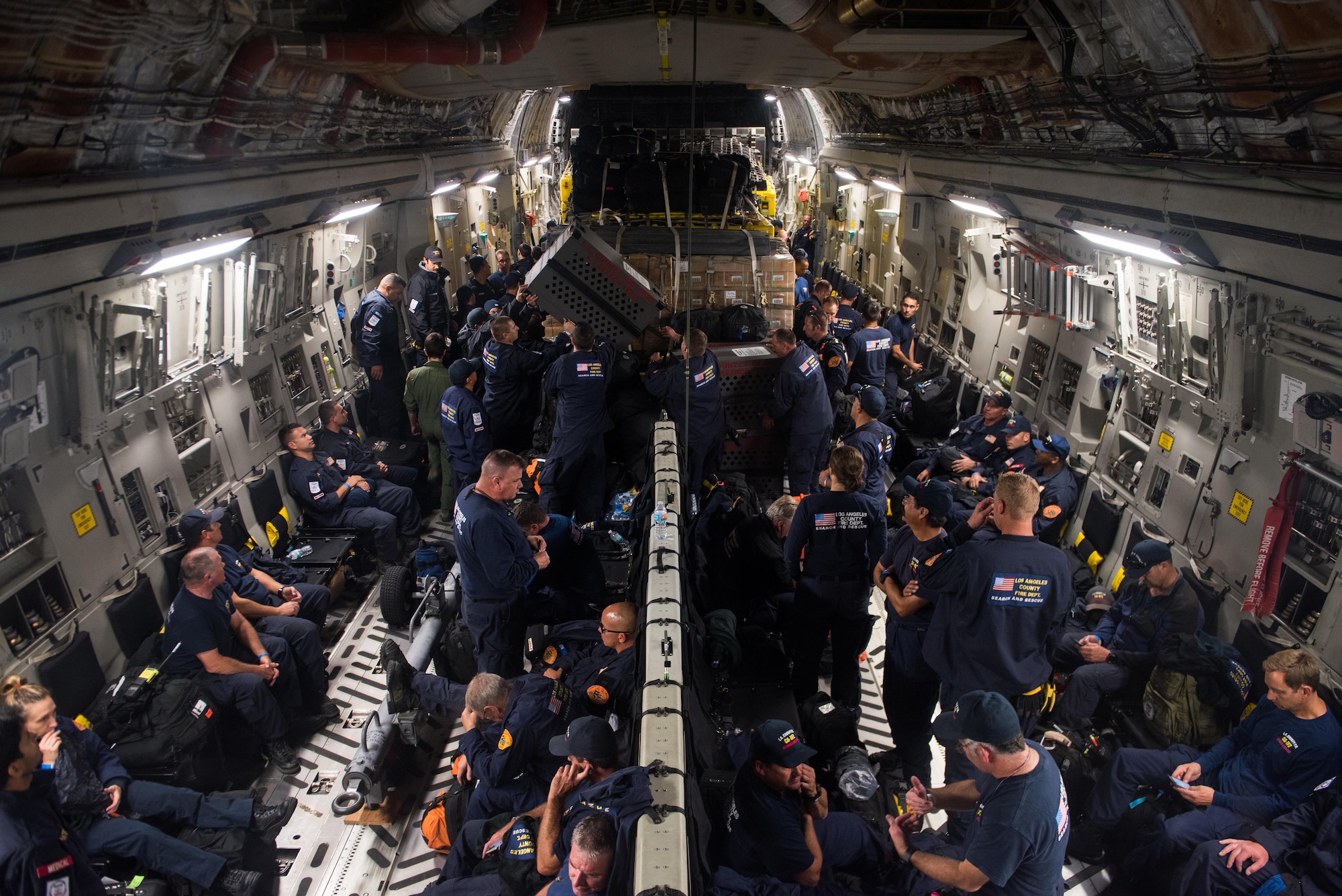 Members of a U.S. Agency for International Development elite disaster prepare to fly on a Travis Air Force Base C-17 Globemaster III at March Air Reserve Base, Calif., Sept. 20, 2017. At the request of the Mexican government, the team was headed for Mexico to support search and rescue efforts after a 7.1 magnitude earthquake struck the country.  (U.S. Air Force photo by Master Sgt. Joseph Swafford)