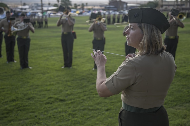 Chief Warrant Officer 3 Stephanie Wire, 1st Marine Division Band, conducts the pre-serenade at the rededication ceremony of 7th Marine Regiment at Lance Cpl Torrey L. Gray Field, Marine Corps Air Ground Combat Center, Twentynine Palms, Calif., Sept. 15th, 2017. The 7th Marine Regiment celebrated its 100th year anniversary with a rededication of the regimental battle colors and a parade of troops. (U.S. Marine Corps photo by Lance Cpl Preston Morris)