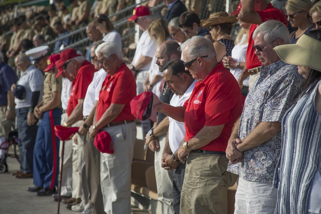 Veterans of the 7th Marine Regiment bow their heads during the invocation of the ceremony at Lance Cpl Torrey L. Gray Field, Marine Corps Air Ground Combat Center, Twentynine Palms, Calif., Sept. 15th, 2017. The 7th Marine Regiment celebrated its 100th anniversary with a rededication of regimental battle colors and a parade of troops. (U.S. Marine Corps photo by Lance Cpl Preston Morris)