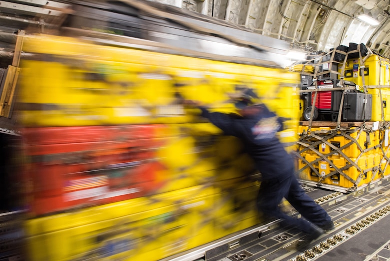 Stephen Jones, a member of the Los Angeles County Fire Department and a U.S. Agency for International Development elite disaster team member, offloads cargo from a Travis Air Force Base, Calif., Globemaster III at the Mexico City International Airport, Sept. 21, 2017. At the request of the Mexican government, the team arrived in Mexico to support search and rescue efforts after a 7.1 magnitude earthquake struck the country.  (U.S. Air Force photo by Master Sgt. Joseph Swafford)