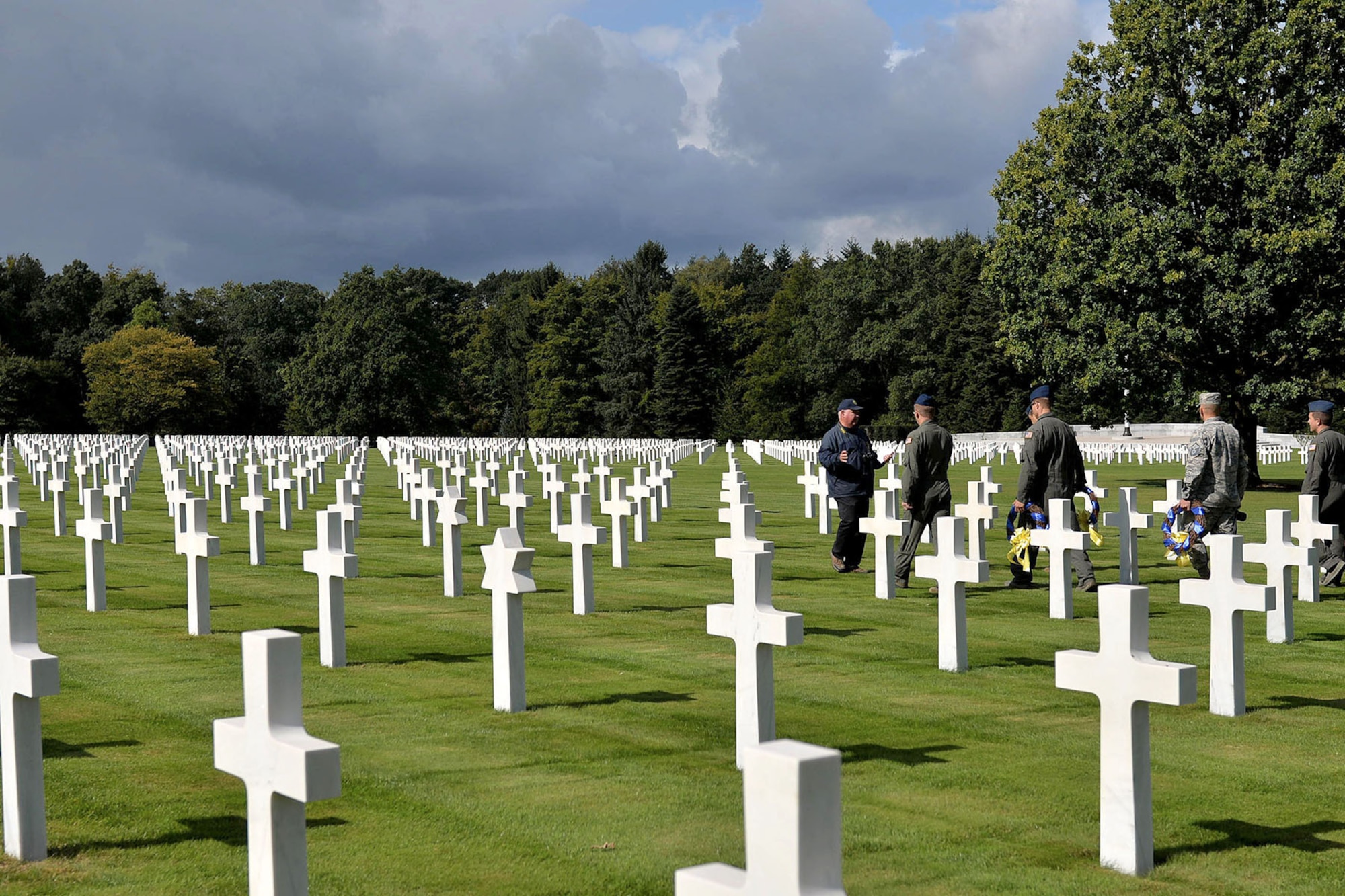U.S Air Force members form Little Rock Air Force Base, Ark., get to know the history of the grounds at Ardennes American Military Cemetery in Neupre, Belgium, before a wreath laying ceremony Sept. 12, 2017. The ceremony honored several squadrons from WWII that have roots back to current units at Little Rock AFB. (U.S. Air Force photo by Airman 1st Class Codie Collins)